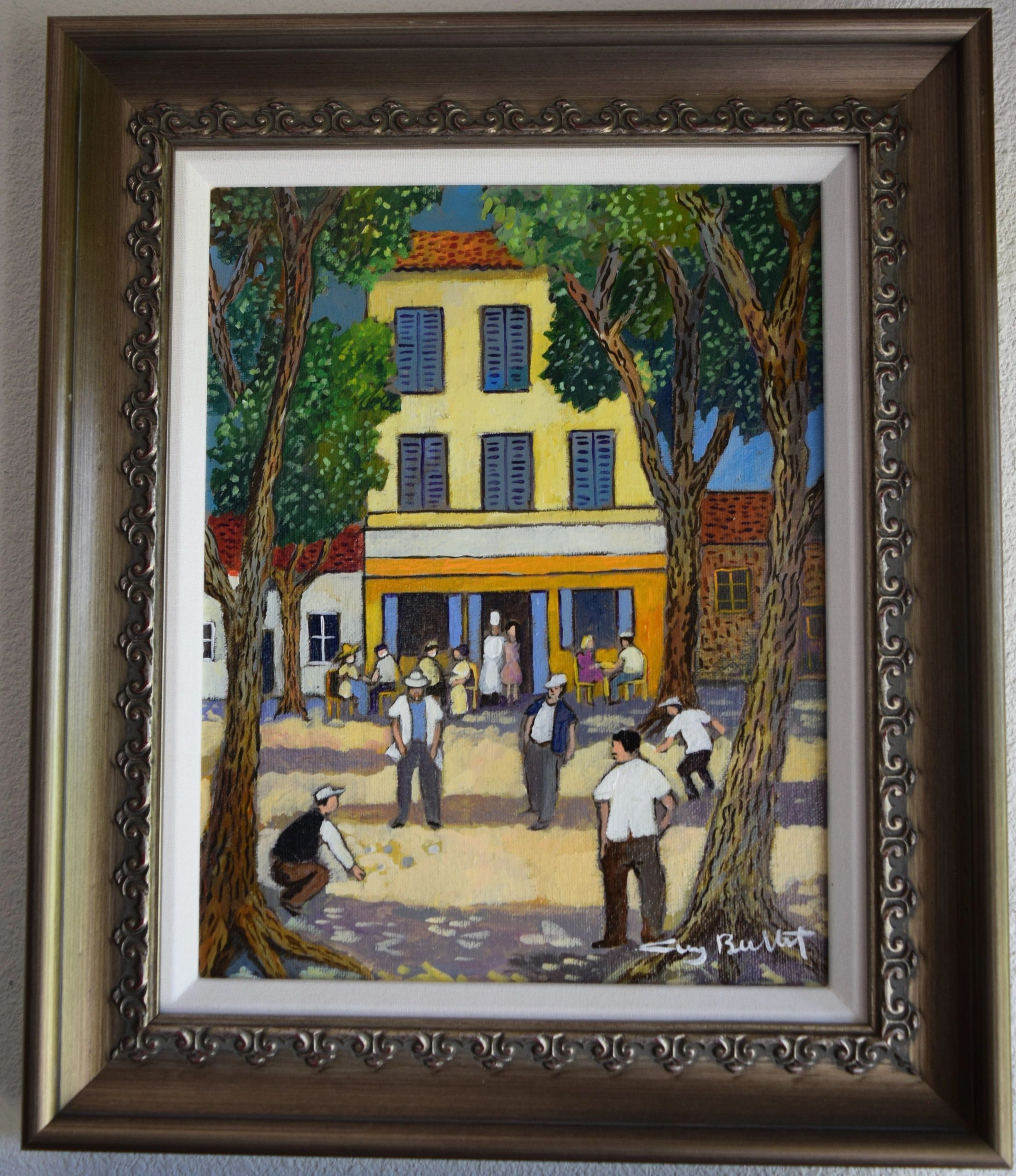 Framed colorful village street painting by Guy Buffet